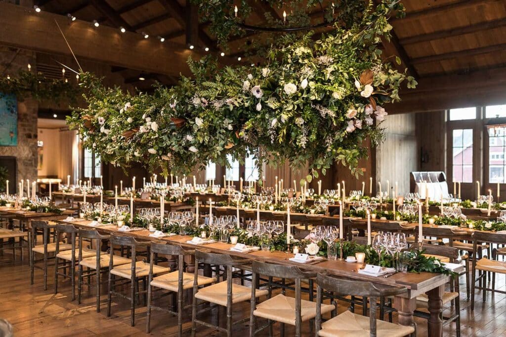 Rustic Barn Wedding decor with hanging floral and greenery arrangements