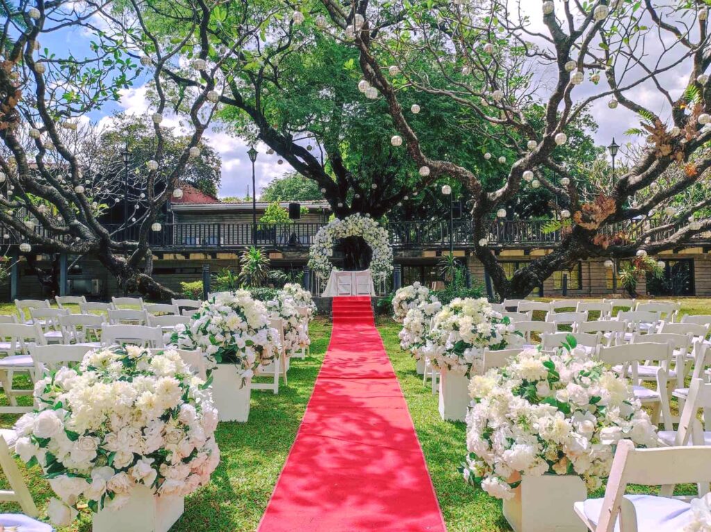 Outdoor Garden Wedding Site with beautiful line of white chairs