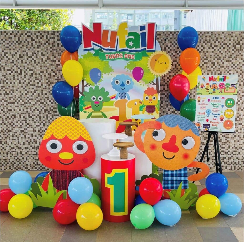 Noodle Pals Birthday party decor with colorful balloon clusters and Kernel & Noodle Cutouts