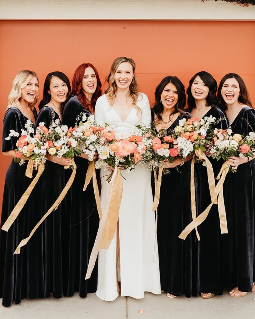 Photo of Bridesmaids beside the bride, wearing stunning black dress