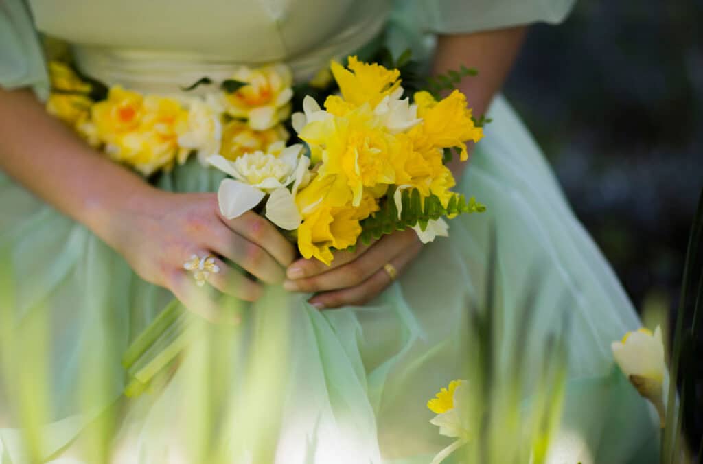 Bride Holding Daffodil Bouquet on her lap