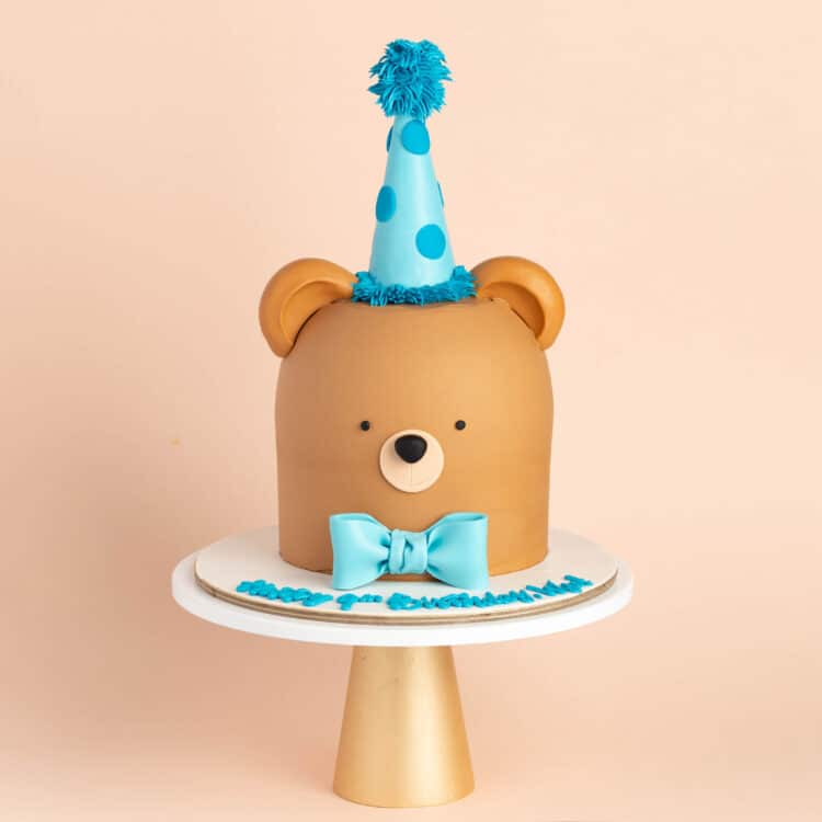 Teddy Bear Birthday Cake with cute round shape, brown icing, Bear's ears and birthday hat