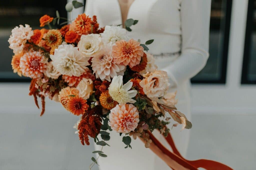 Bride holding Flower bouquet made of Dahlia