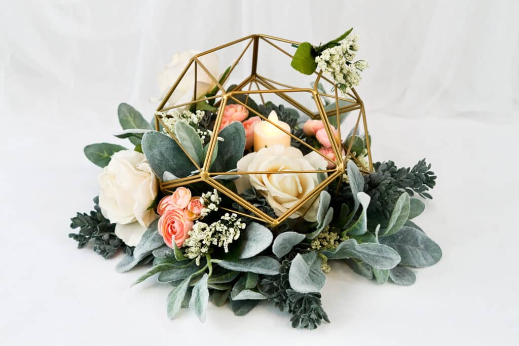 Geometric floral centerpiece with eucalyptus, ivy, rose and peony arrangemetns