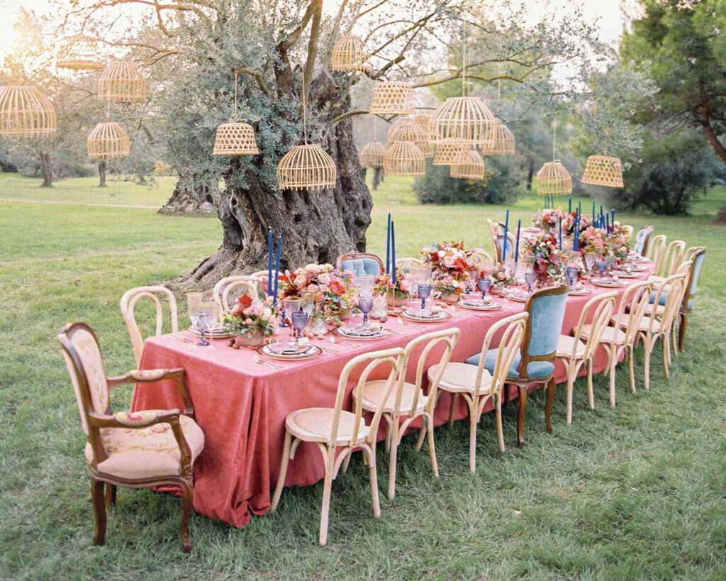 Wedding celebrated in the backyard with long table, floral arrangements and wooden table