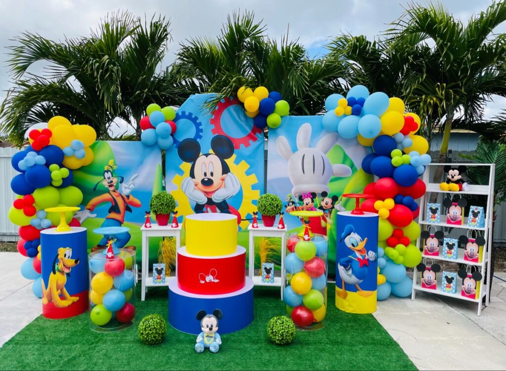 Festive Party Decor With Colorful balloon Garland, Mickey Mouse Banner, Donald Duck Cutout and more at Mickey Mouse Birthday Party