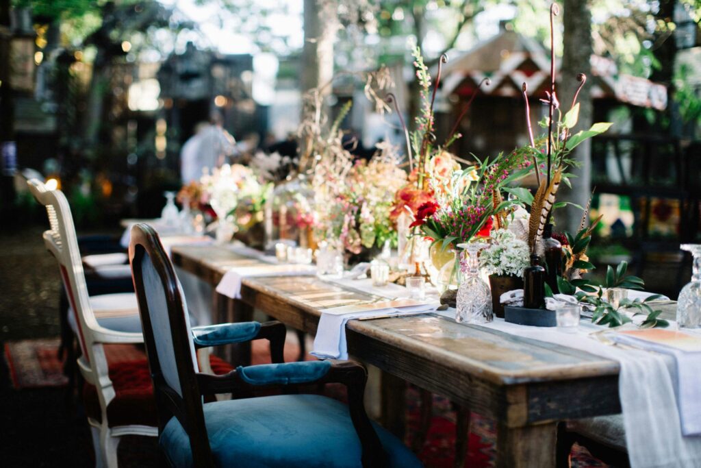 Beautiful Greenery and Floral table centerpiece with folded white tablecloth