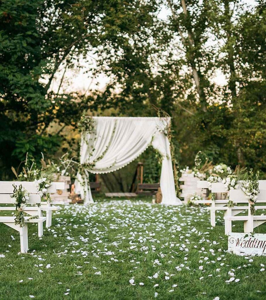 Hilary Duff & Matthew Koma Backyard Wedding with Wooden Floral Arch and curtain