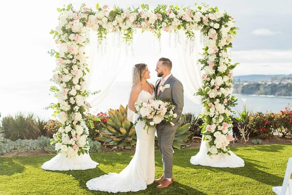 Beautiful Couple Under Peony Wedding Arch