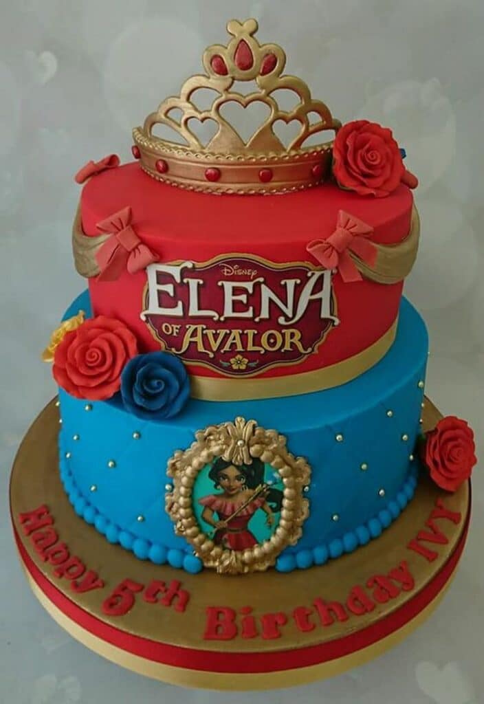 two tiered Royal Elena Cake with blue and red frosting and edible Princess tiara