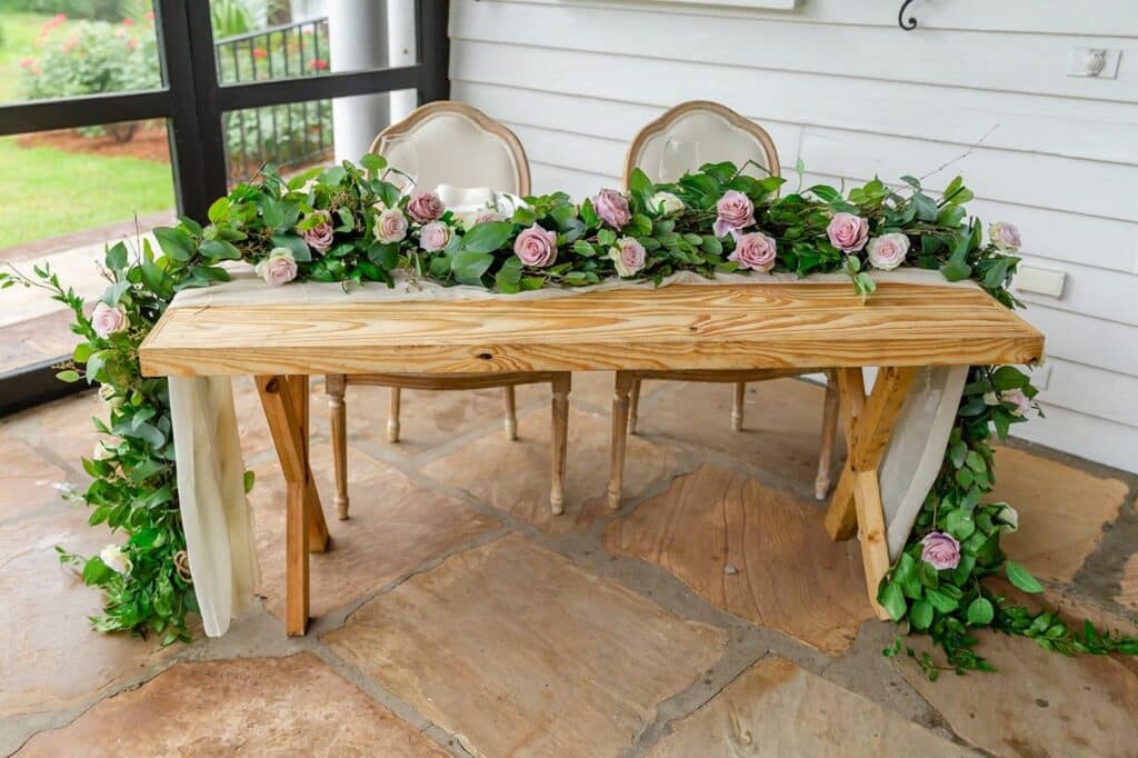 Rustic Wooden table with Floral Garlands and Centerpieces