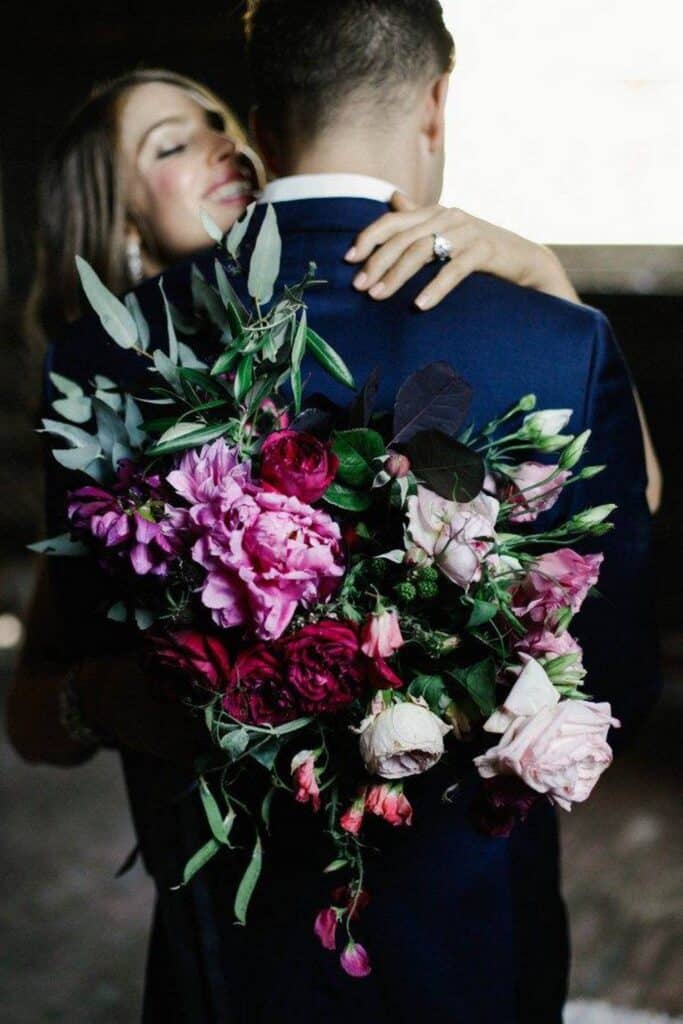 Bride's holding flower bouquet made of Peony arrangement