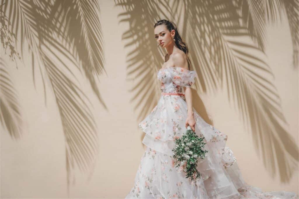 Beautiful Bride in gorgeous white bridal dress while holding flower bouquet