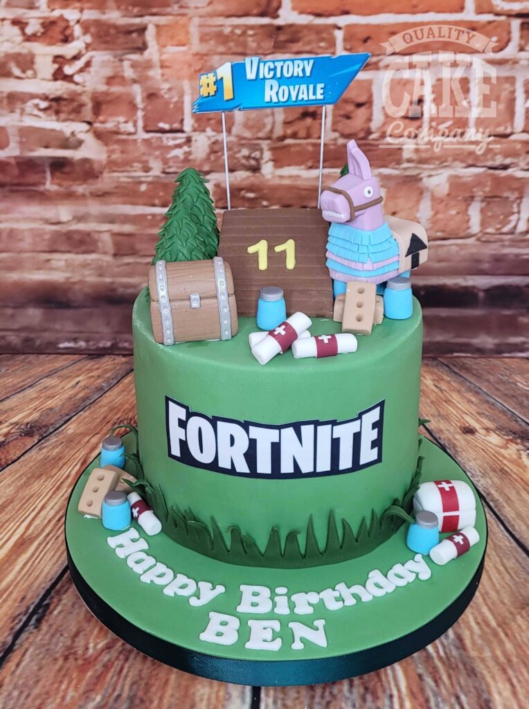 Fortnite birthday cake with green frosting, llama and supply drop toppers